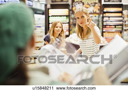 Mother and daughter in grocery store View Large Photo Image Stock Image - Mother and daughter in grocery store. Fotosearch