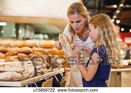 Mother and daughter in grocery store View Large Photo Image Stock Image - Mother and daughter in grocery store. Fotosearch