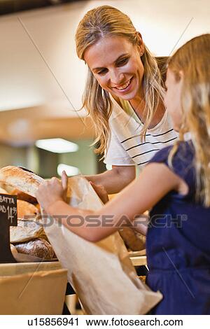 Mother and daughter in grocery store View Large Photo Image Stock Image - Mother and daughter in grocery store. Fotosearch