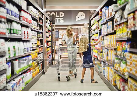 Mother and daughter in grocery store View Large Photo Image Stock Photo - Mother and daughter in grocery store. Fotosearch