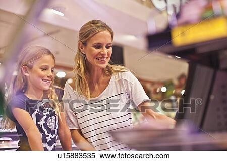 Mother and daughter in grocery store View Large Photo Image Stock Photography - Mother and daughter in grocery store. Fotosearch
