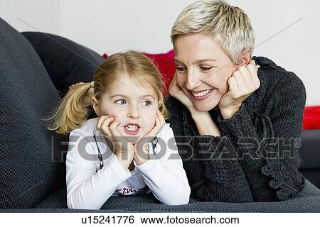 Mother and daughter laying on sofa View Large Photo Image Stock Photograph - Mother and daughter laying on sofa. Fotosearch