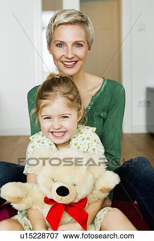 Mother and daughter sitting on floor View Large Photo Image Stock Photo - Mother and daughter sitting on floor. Fotosearch