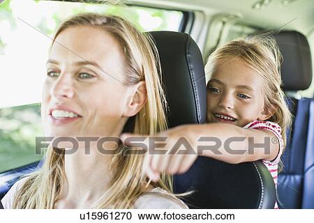 Stock Image - Mother and daughter talking in car. Fotosearch