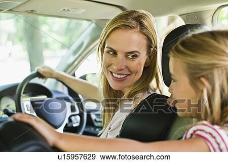 Stock Photo - Mother and daughter talking in car. Fotosearch