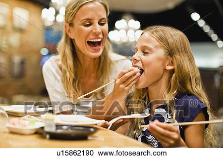 Mother and daughter using chopsticks View Large Photo Image Stock Image - Mother and daughter using chopsticks. Fotosearch