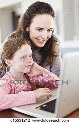 Mother and daughter using laptop View Large Photo Image Stock Image - Mother and daughter using laptop. Fotosearch