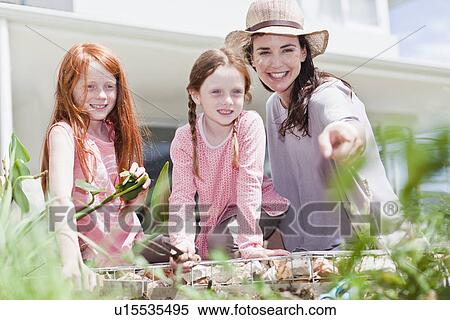 Mother and daughters gardening View Large Photo Image Stock Photography - Mother and daughters gardening. Fotosearch