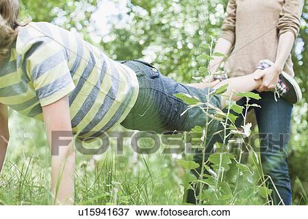 Mother and son playing in park View Large Photo Image Stock Photo - Mother and son playing in park. Fotosearch