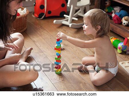 Stock Image - Mother and son playing with blocks. Fotosearch