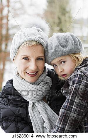 Mother carrying daughter in snow View Large Photo Image Picture - Mother carrying daughter in snow. Fotosearch