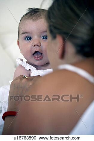 Mother playing with baby on bed View Large Photo Image Stock Image - Mother playing with baby on bed. Fotosearch