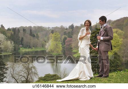 Newlywed couple toasting each other View Large Photo Image Picture - Newlywed couple toasting each other. Fotosearch