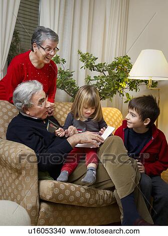 Older couple with grandchildren on sofa View Large Photo Image Stock Image - Older couple with grandchildren on sofa. Fotosearch