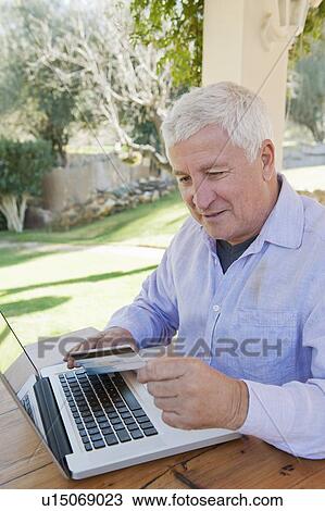 Older man shopping online View Large Photo Image Stock Image - Older man shopping online. Fotosearch
