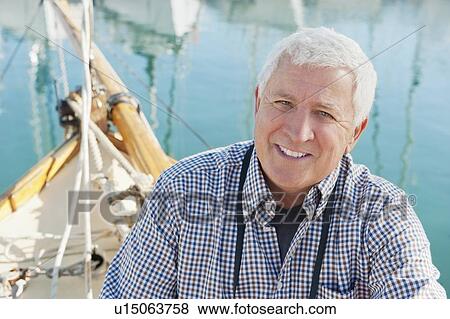 Older man sitting on boat View Large Photo Image Stock Photo - Older man sitting on boat. Fotosearch
