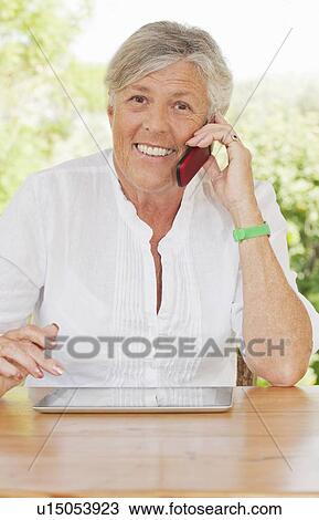 Older woman talking on cell phone View Large Photo Image Stock Image - Older woman talking on cell phone. Fotosearch