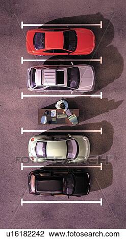 Stock Image - Overhead view of desk in parking lot. Fotosearch