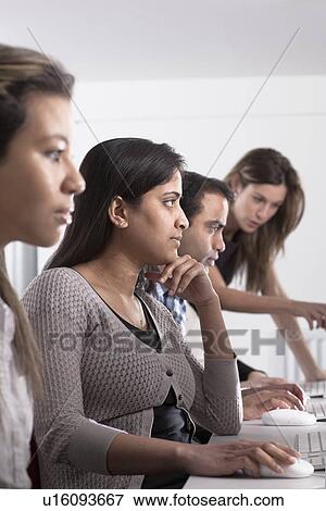 Stock Photo - People using computers at desk. Fotosearch