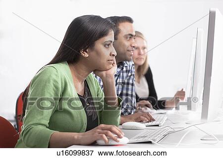 Stock Photo - People using computers at desk. Fotosearch