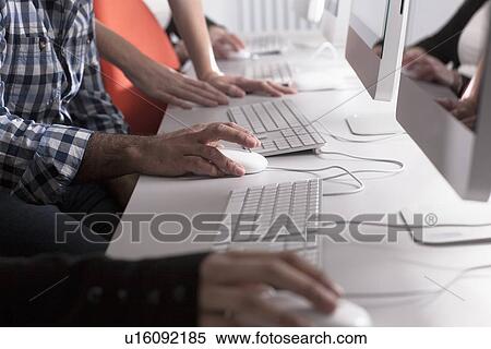 People using computers at desk View Large Photo Image Stock Photography - People using computers at desk. Fotosearch
