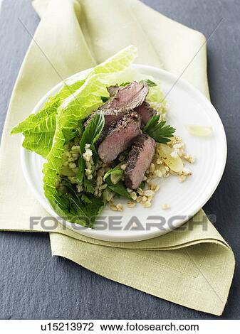 Stock Image - Plate of lamb and grape salad. Fotosearch