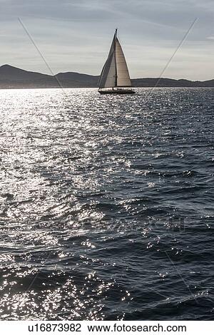 Sailboat on still lake View Large Photo Image Stock Image - Sailboat on still lake. Fotosearch