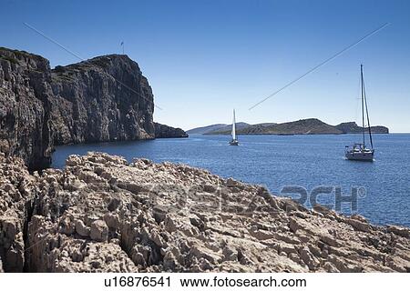 Stock Image - Sailboats on still lake. Fotosearch
