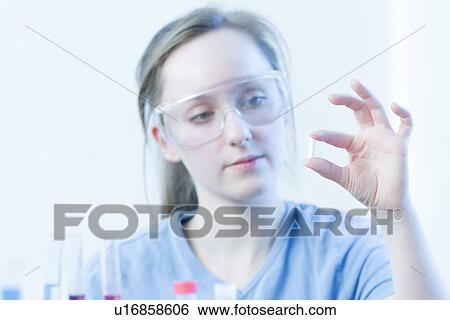 Scientist examining pill in lab View Large Photo Image Stock Photograph - Scientist examining pill in lab. Fotosearch