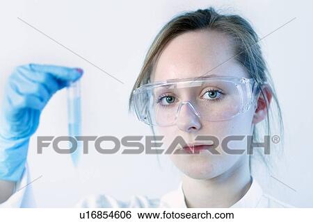 Stock Photograph - Scientist examining test tube in lab. Fotosearch