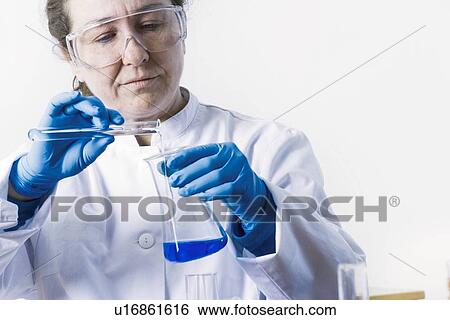 Scientist pouring liquid into beaker View Large Photo Image Stock Photograph - Scientist pouring liquid into beaker. Fotosearch