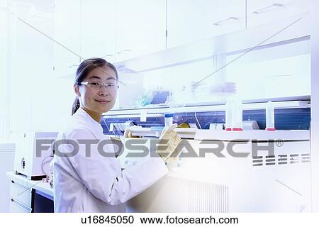 Scientist using equipment in lab View Large Photo Image Stock Image - Scientist using equipment in lab. Fotosearch