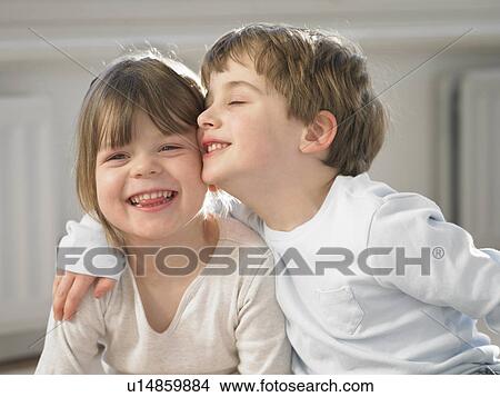Picture - Smiling children hugging indoors. Fotosearch