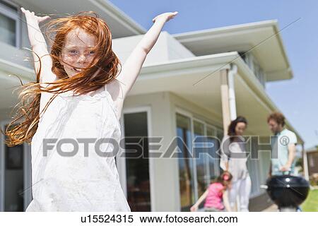 Smiling girl cheering in backyard View Large Photo Image Stock Photography - Smiling girl cheering in backyard. Fotosearch