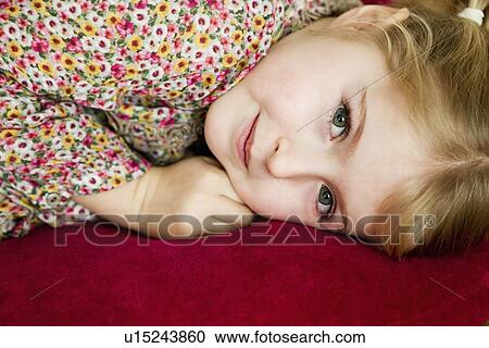 Smiling girl laying on pillow View Large Photo Image Stock Image - Smiling girl laying on pillow. Fotosearch