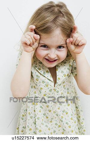 Smiling girl making a face View Large Photo Image Picture - Smiling girl making a face. Fotosearch