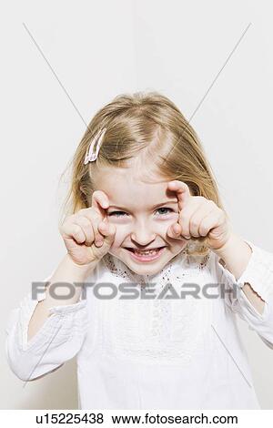 Smiling girl making a face View Large Photo Image Stock Photo - Smiling girl making a face. Fotosearch