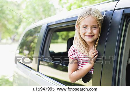Smiling girl standing in car window View Large Photo Image Stock Photography - Smiling girl standing in car window. Fotosearch