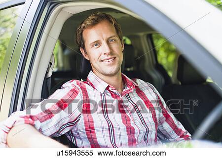 Smiling man sitting in car View Large Photo Image Stock Photography - Smiling man sitting in car. Fotosearch