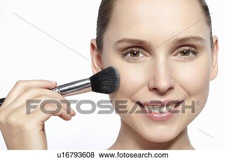 Smiling woman applying makeup View Large Photo Image Stock Photo - Smiling woman applying makeup. Fotosearch