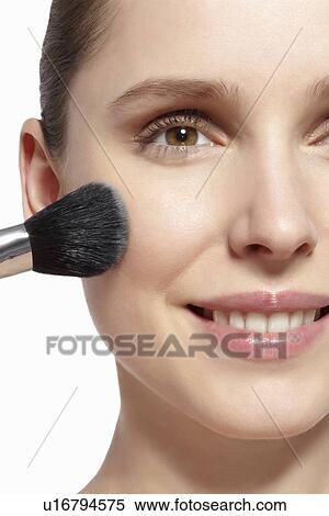 Smiling woman applying makeup View Large Photo Image Stock Photography - Smiling woman applying makeup. Fotosearch