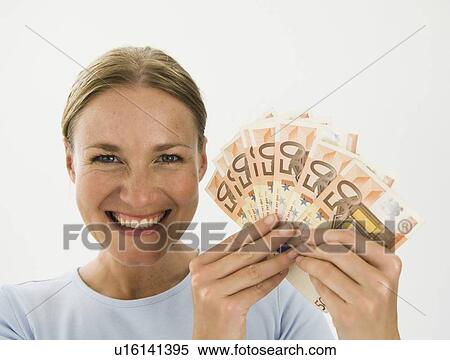 Stock Photography - Smiling woman holding Euro notes. Fotosearch