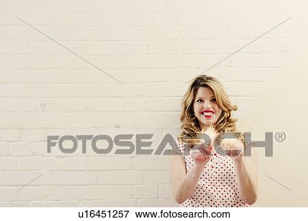 Stock Photo - Smiling woman holding sparklers. Fotosearch