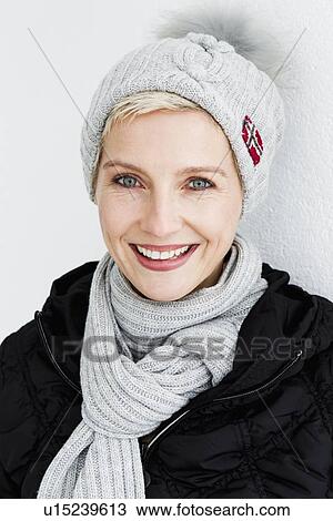 Smiling woman wearing hat and scarf View Large Photo Image Stock Image - Smiling woman wearing hat and scarf. Fotosearch