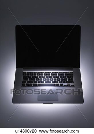 Stock Image - Spotlight on laptop computer. Fotosearch