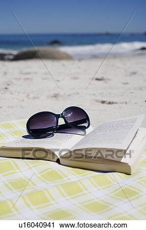 Sunglasses on book on beach View Large Photo Image Stock Image - Sunglasses on book on beach. Fotosearch