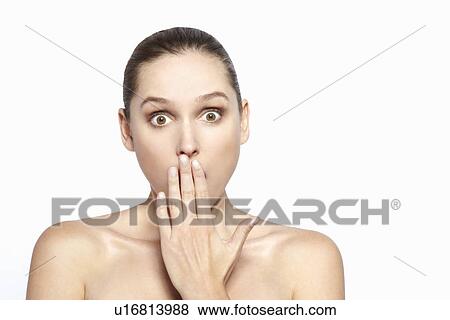 Surprised woman covering her mouth View Large Photo Image Stock Photo - Surprised woman covering her mouth. Fotosearch