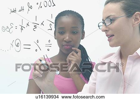 Teacher and student writing on glass View Large Photo Image Picture - Teacher and student writing on glass. Fotosearch