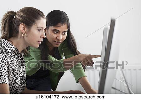 Teacher helping student use computer View Large Photo Image Stock Image - Teacher helping student use computer. Fotosearch
