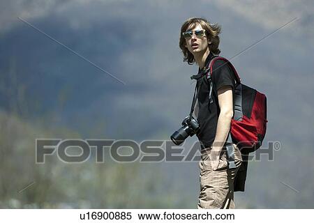 Teenage boy hiking with camera View Large Photo Image Stock Photography - Teenage boy hiking with camera. Fotosearch
